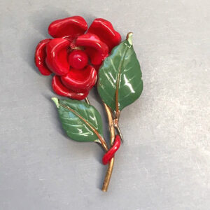 TRIFARI fur clip with red enameled flowers and green leaves, 1941