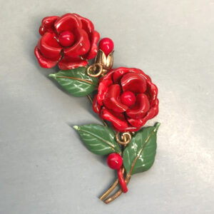 TRIFARI fur clip with red enameled flowers and green leaves in a gold tone setting,1941