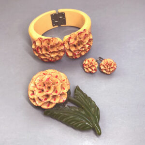 BAKELITE butterscotch flower carved set of a hinged clamper bracelet, a dress clip and screw back earrings