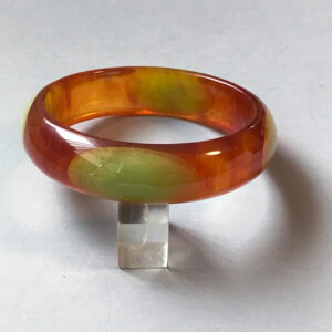 SHULTZ bakelite lightly marbled ice tea colored bangle with elongated aqua dots
