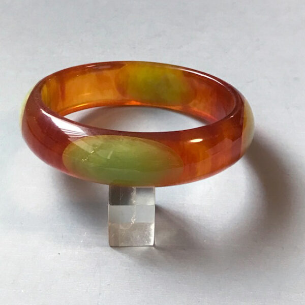 SHULTZ bakelite lightly marbled ice tea colored bangle with elongated aqua dots