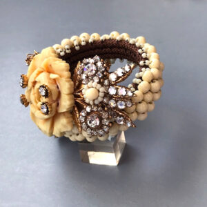 LARRY VRBA early coil bracelet of carved cream colored flowers, cream glass beads, clear rhinestones and cream seed beads